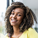 Portrait of a brazilian young woman with curly hair looking at c