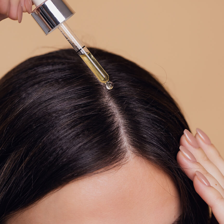 close-up-view-of-young-woman-putting-hair-serum-fo-2025-02-16-13-30-35-utc (1)