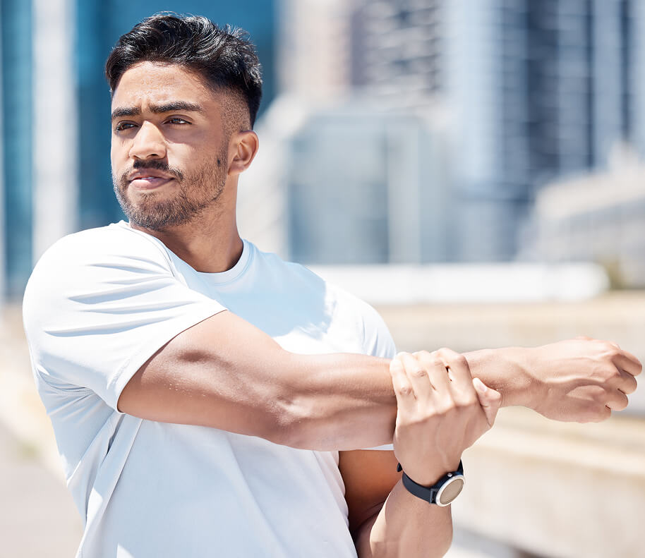 fit-young-mixed-race-man-stretching-his-arms-befor-2025-04-06-11-31-34-utc